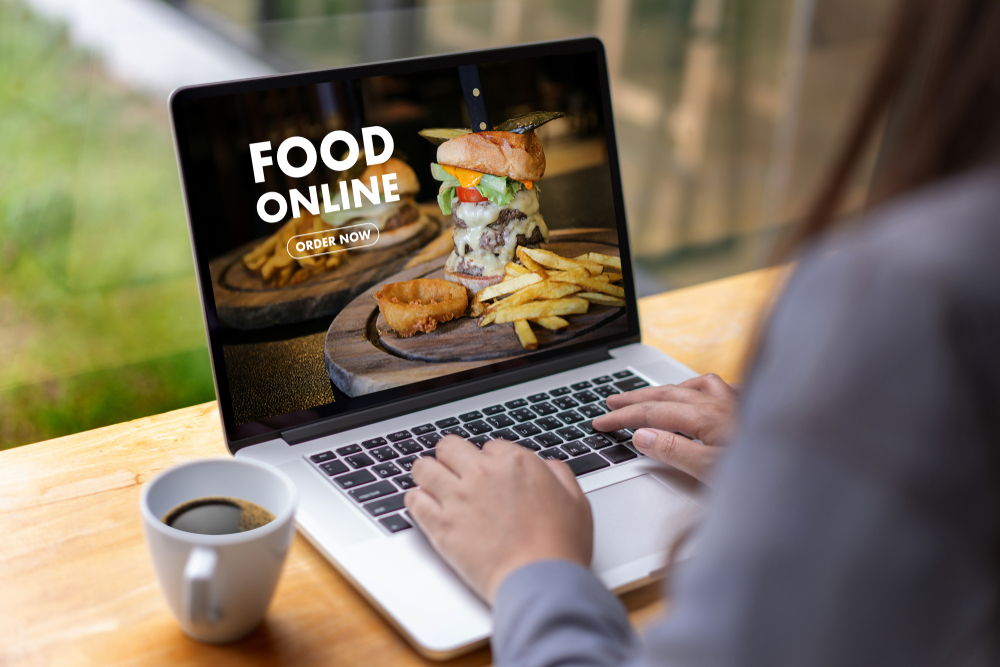 a woman ordering food through her laptop