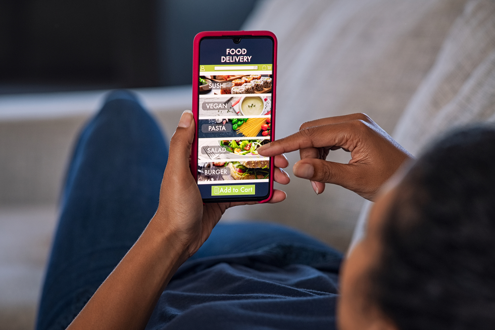 a man ordering food online through his phone