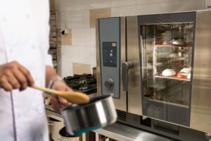 a chef cooking in a small pan